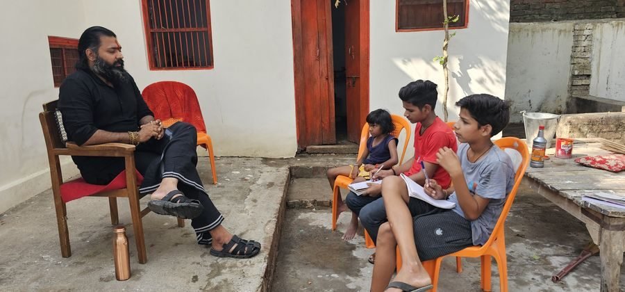 Kabeer Ji Maharaj teaching village children in open-air session — authentic gurukul-style education, learning without infrastructure
