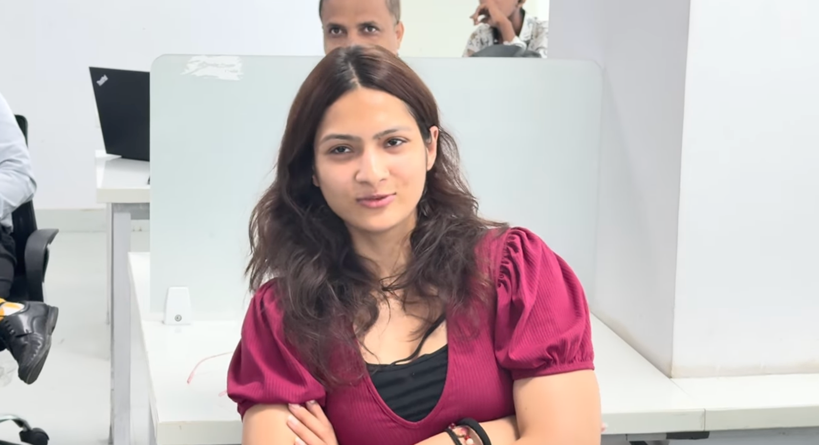 Young professional woman in maroon top — attentively listening to Kabeer Goswami's corporate talk on AI and future of work।